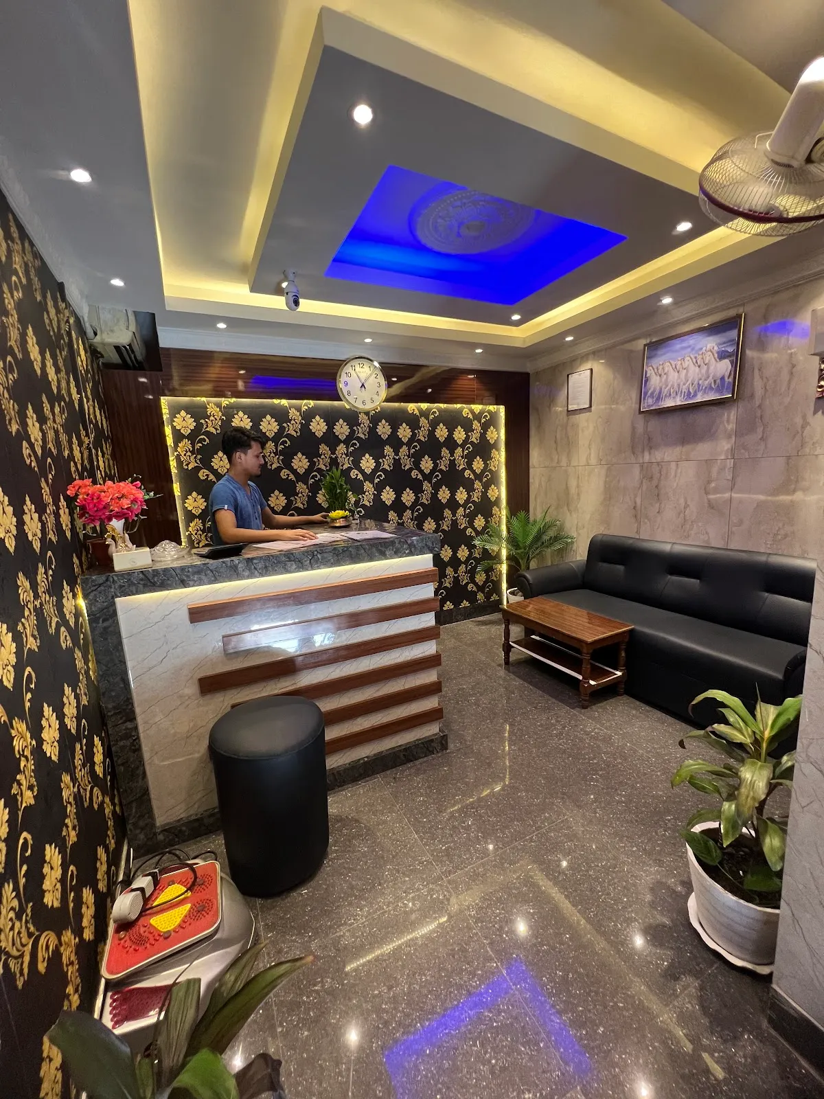 Green Spa reception desk with warm lighting and fresh flowers